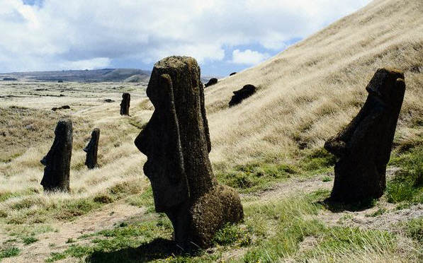 Stone statues of a heads on the outer slope of Rano Raraku, a soft stone quarry on Easter Island