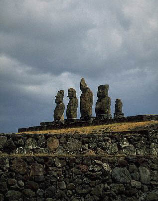 Five stone moai on a hill supported by stone walls at Ahu Tahai, Easter Island