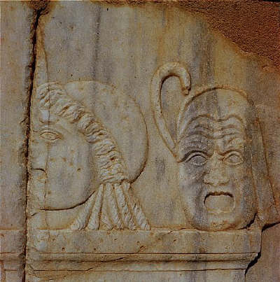 Sculptural reliefs of two masks on the base of the stage of the Roman theater of Sabrata, Libya, 180 A.D.